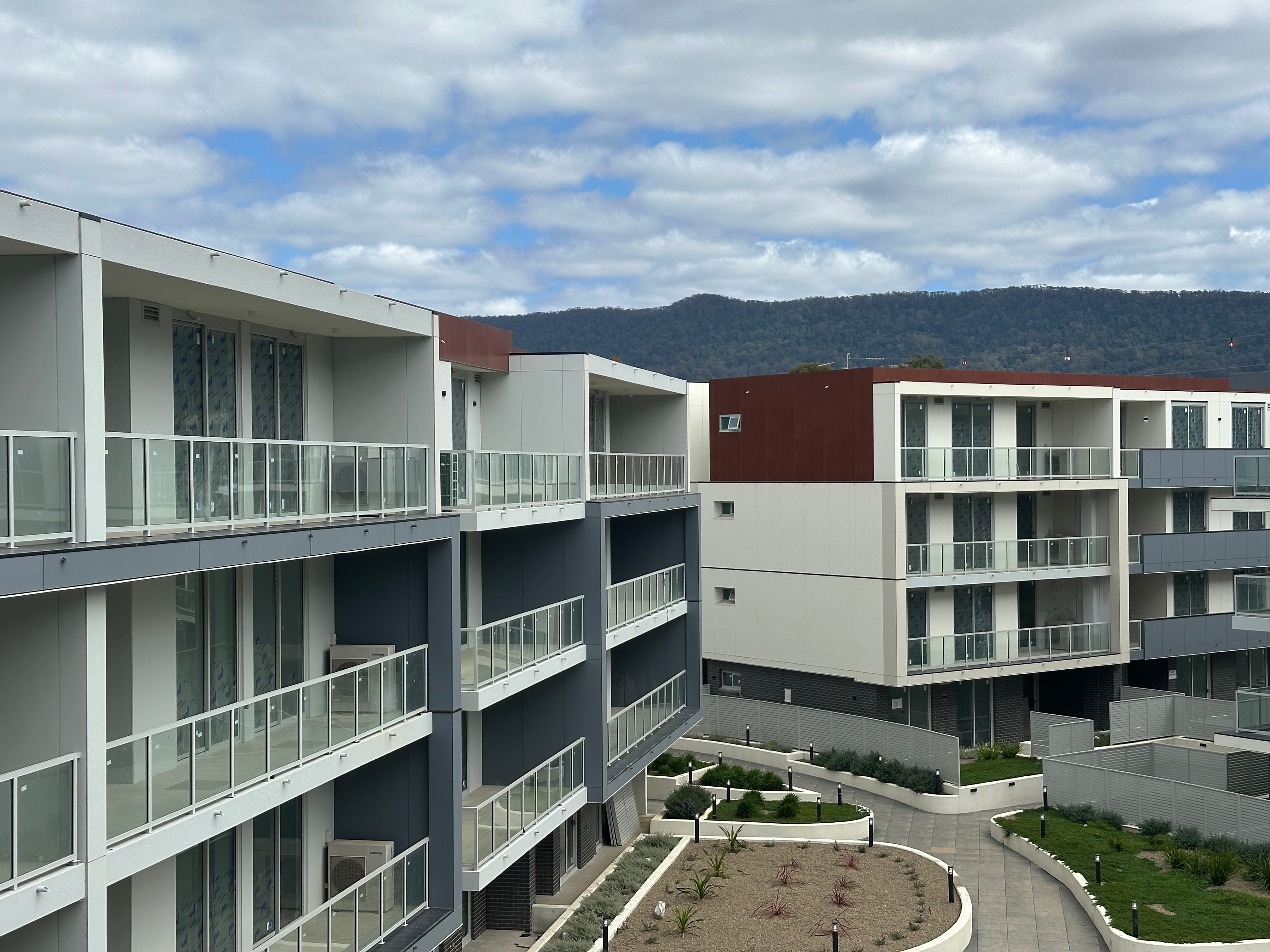 image of apartment building with mountains in the background
