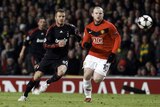 Unhappy homecoming: David Beckham tackles two-goal hero Wayne Rooney in his Old Trafford return.