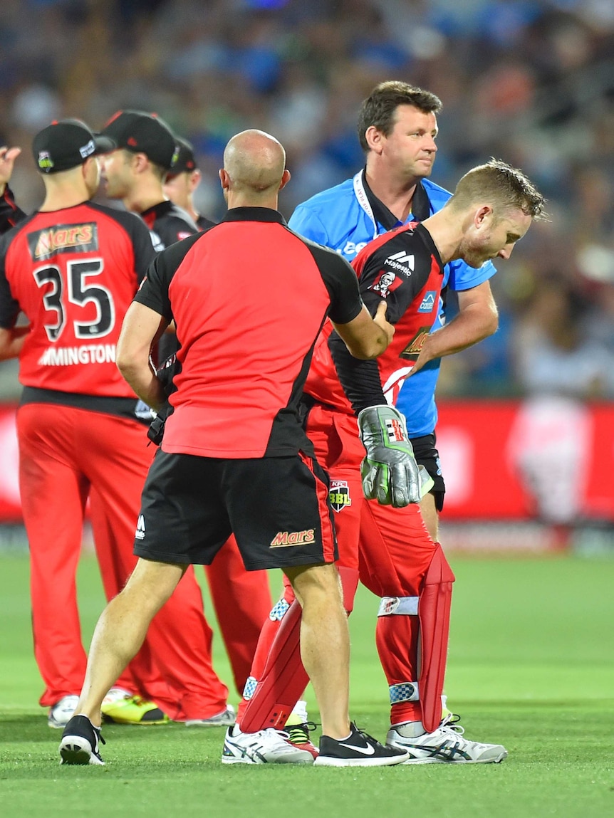 Peter NEvill leaves the field after bat hit him in the face