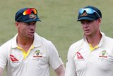 David Warner and Steve Smith leave the pitch after Australia beats South Africa in Durban.