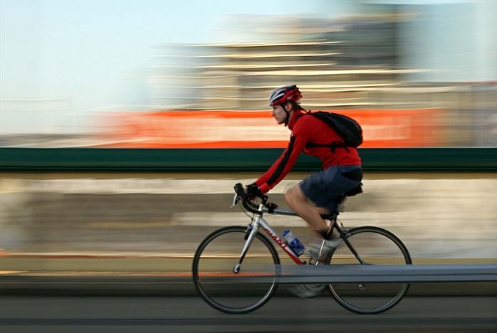 A cyclist rides along a roadway.