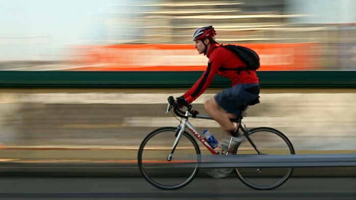 A cyclist rides along a roadway.