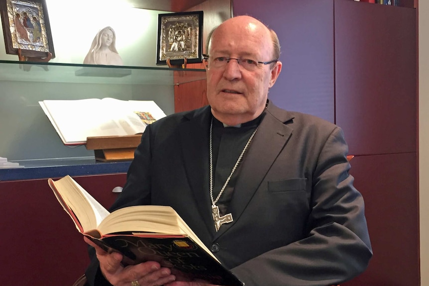 Tasmanian Catholic Archbishop Julian Porteous sits in his office.