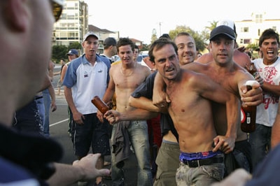 A crowd shows their anger towards police officers during unrest at Cronulla beach (Getty Images)