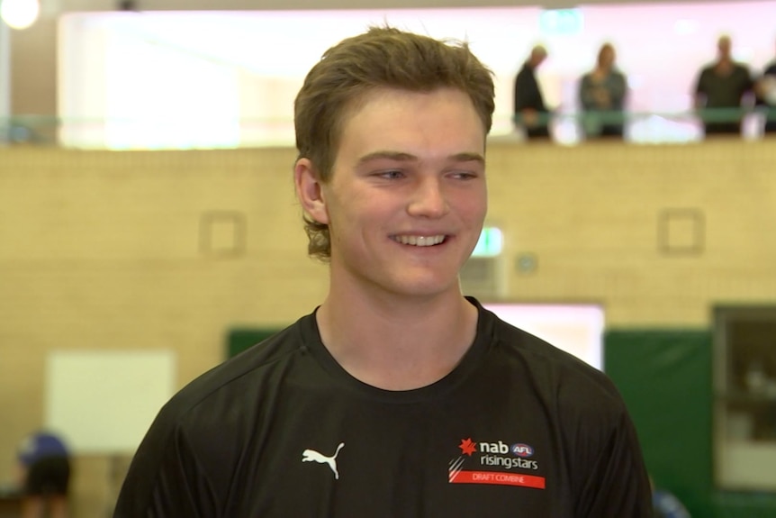 Josh Cripps smiles while talking to the media at the WA AFL Combine in a gymnasium