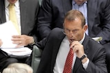 Opposition Leader Tony Abbott listens to Prime Minister Kevin Rudd