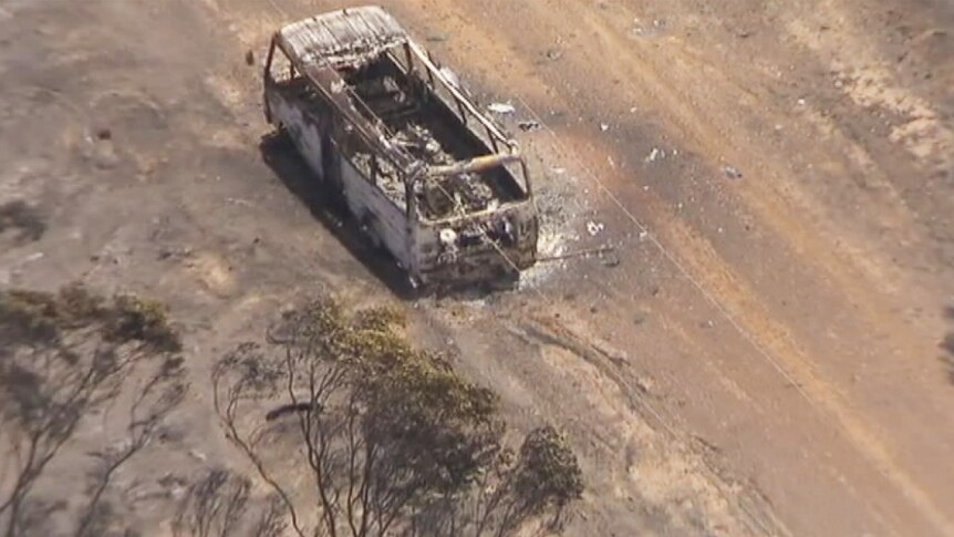 A burnt out vehicle sits on a dirt road near Esperance.