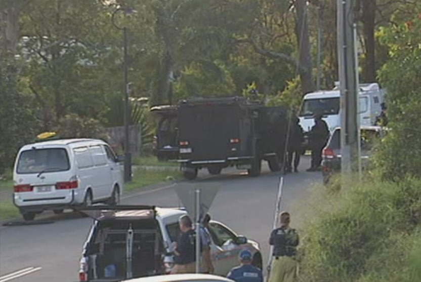 Police and SPER unit officers outside the house in Hart Street in Upper Coomera.