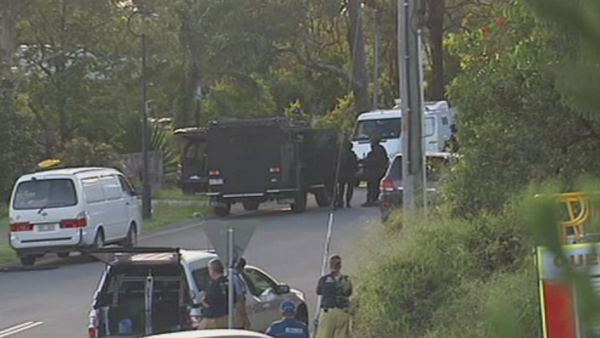 Police and SPER unit officers outside the house in Hart Street in Upper Coomera.