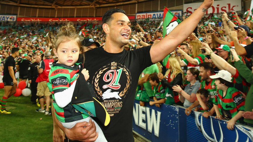 South Sydney captain John Sutton celebrates with the crowd after the NRL Grand Final.