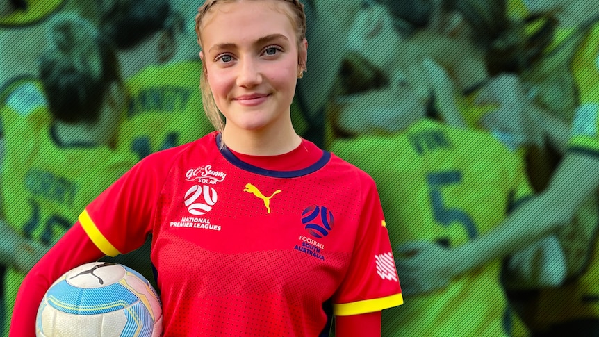 Sian smiles to camera in soccer uniform holding a soccer ball.