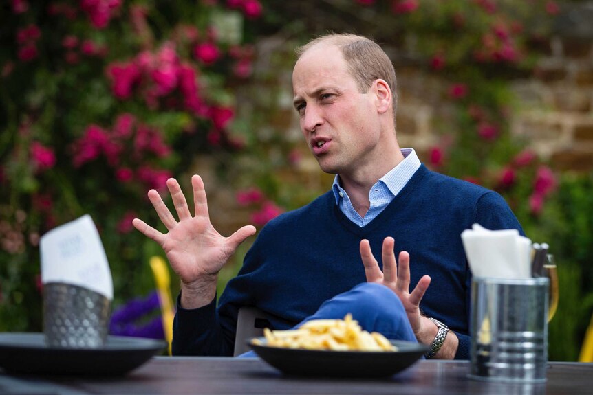 Britain's Prince William talks to the landlord and bar staff at a pub in the UK.