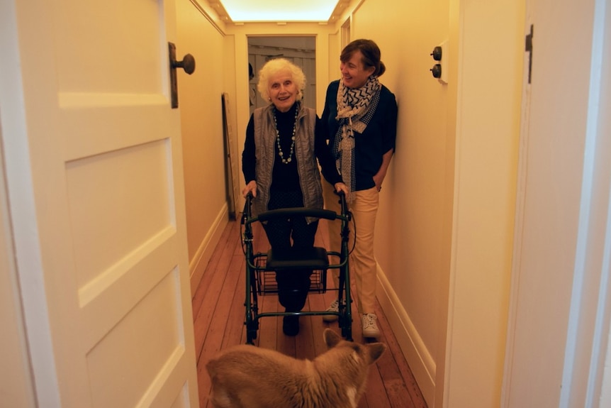 Two women in the hallway of a house