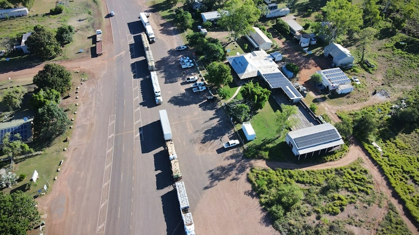 An aerial view of two large trucks on a road