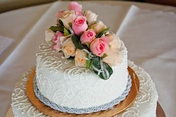 A homemade wedding cake sits on a table