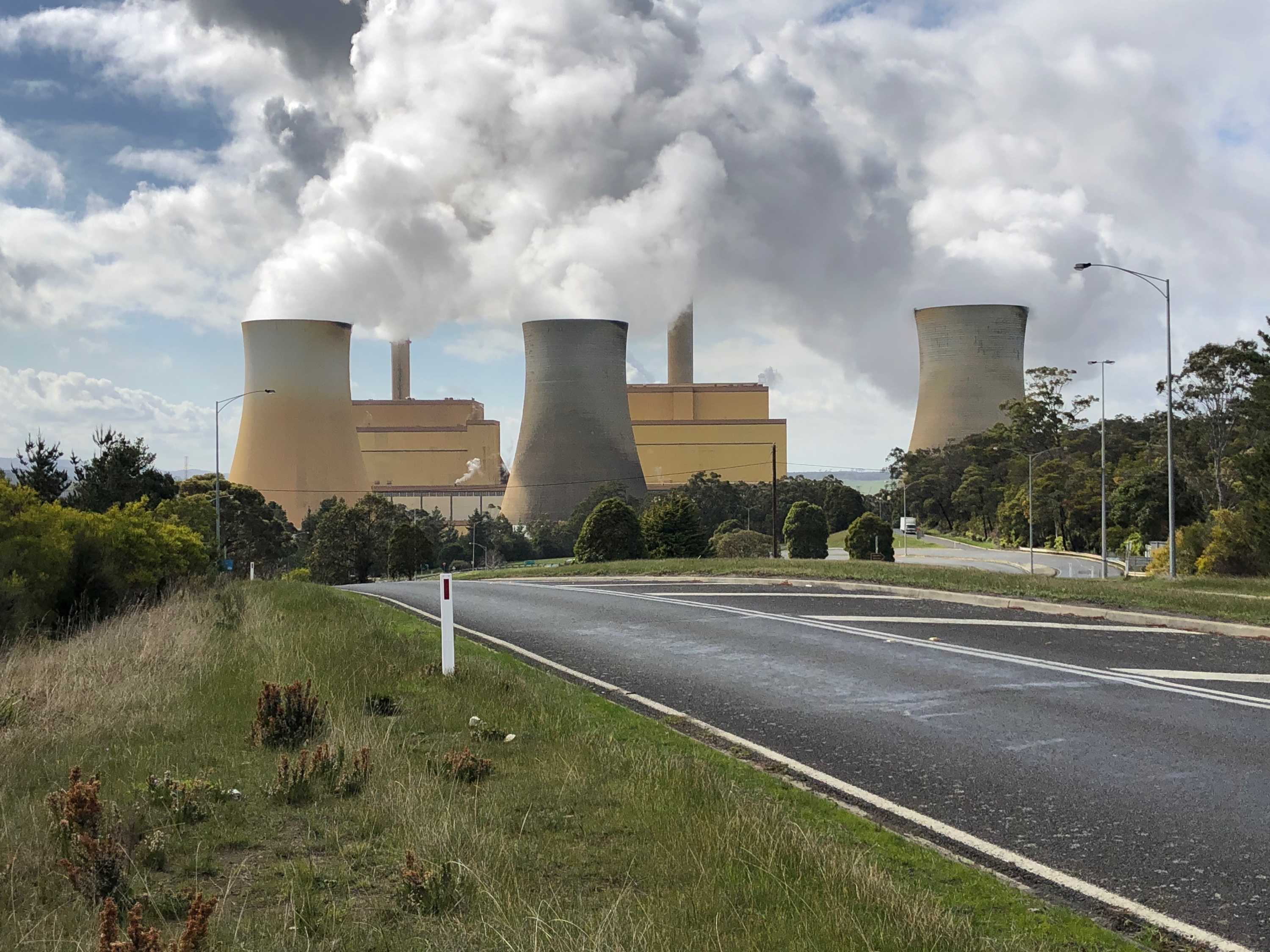 A coal-fired power station in situated among grass and trees