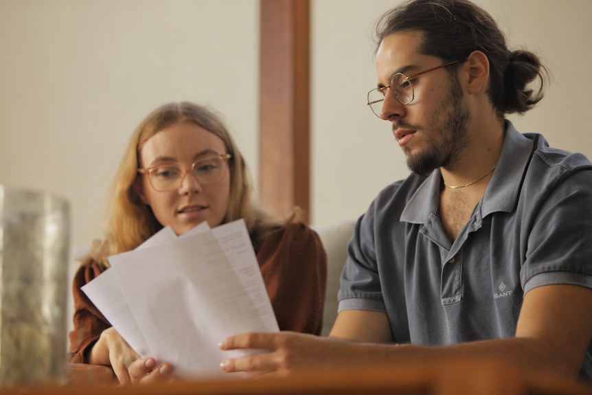 Hugo and Emma looking through documents