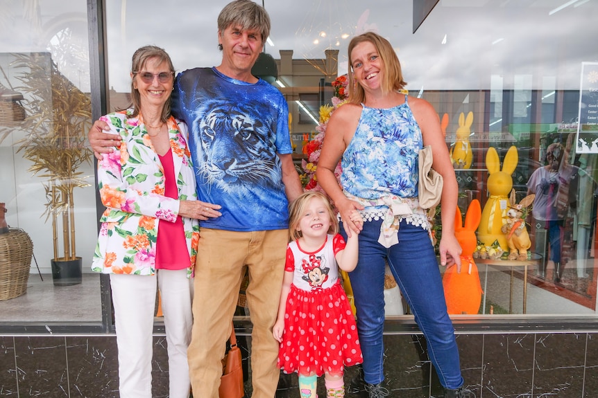 The Duncan family smiling outside the Wauchope Department Store