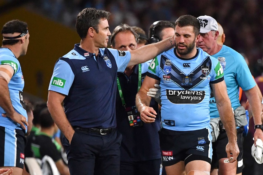 James Tedesco is patted on the back of the head by Brad Fittler