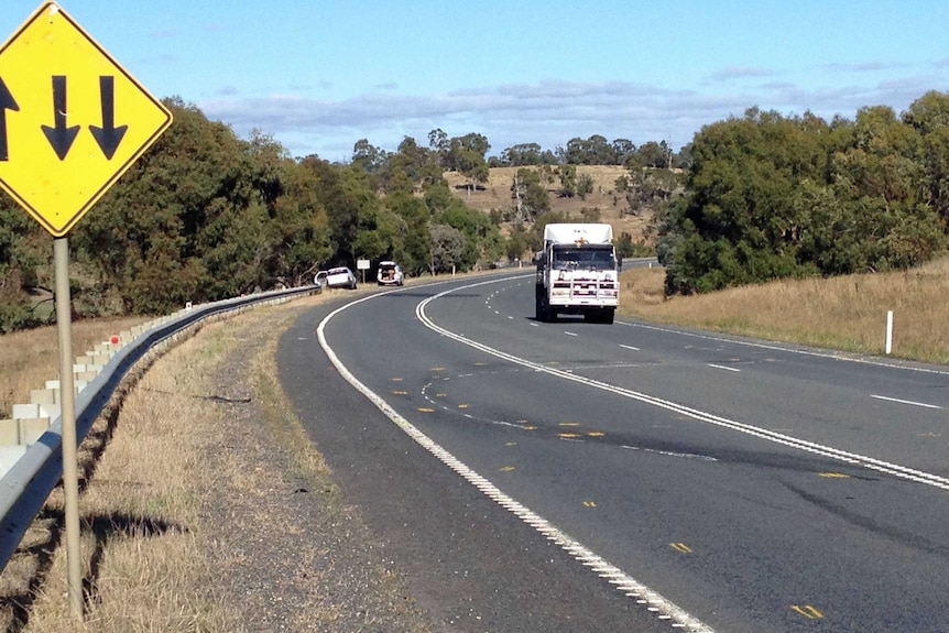 Yellow markings on Tasmania's Midland Highway where DPP Tim Ellis was injured in a fatal crash.