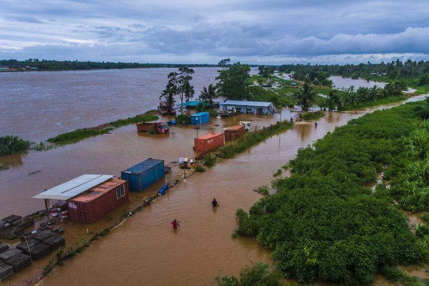 Aerial shot of people wading through floodwaters in Fiji.