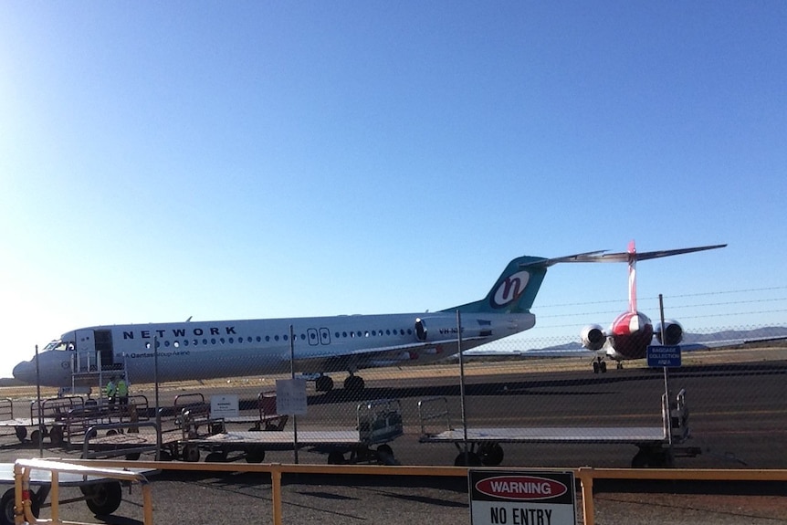 Two planes parked on the runway at Paraburdoo Airport.