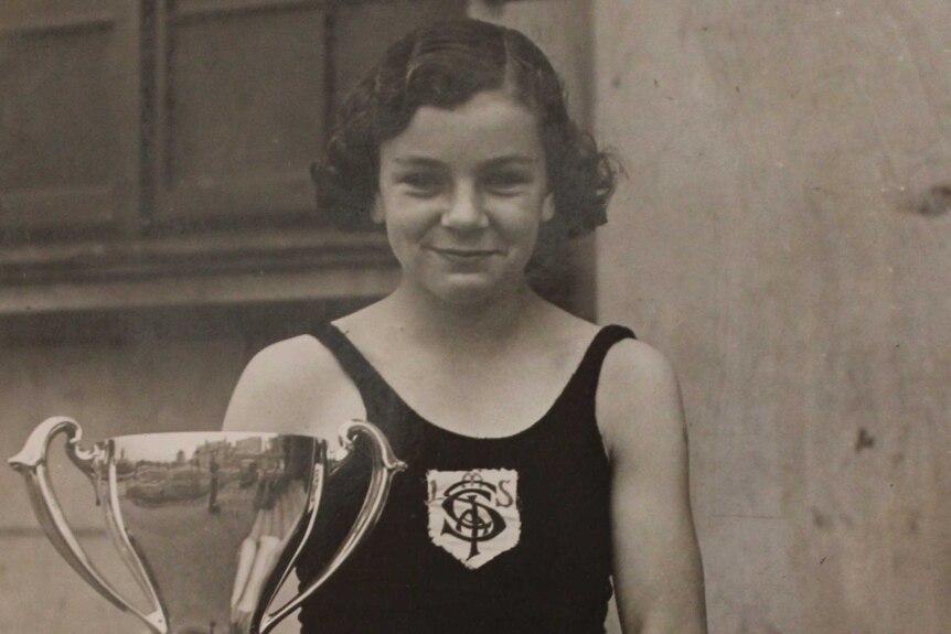 A 14-year-old Margaret Cunningham holds a trophy