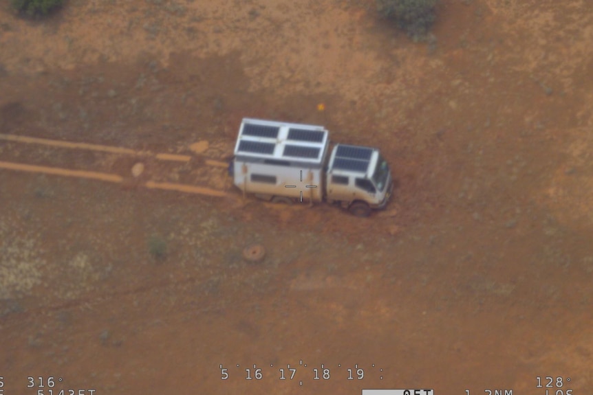 A four-wheel-drive campervan trapped by flooded roads.