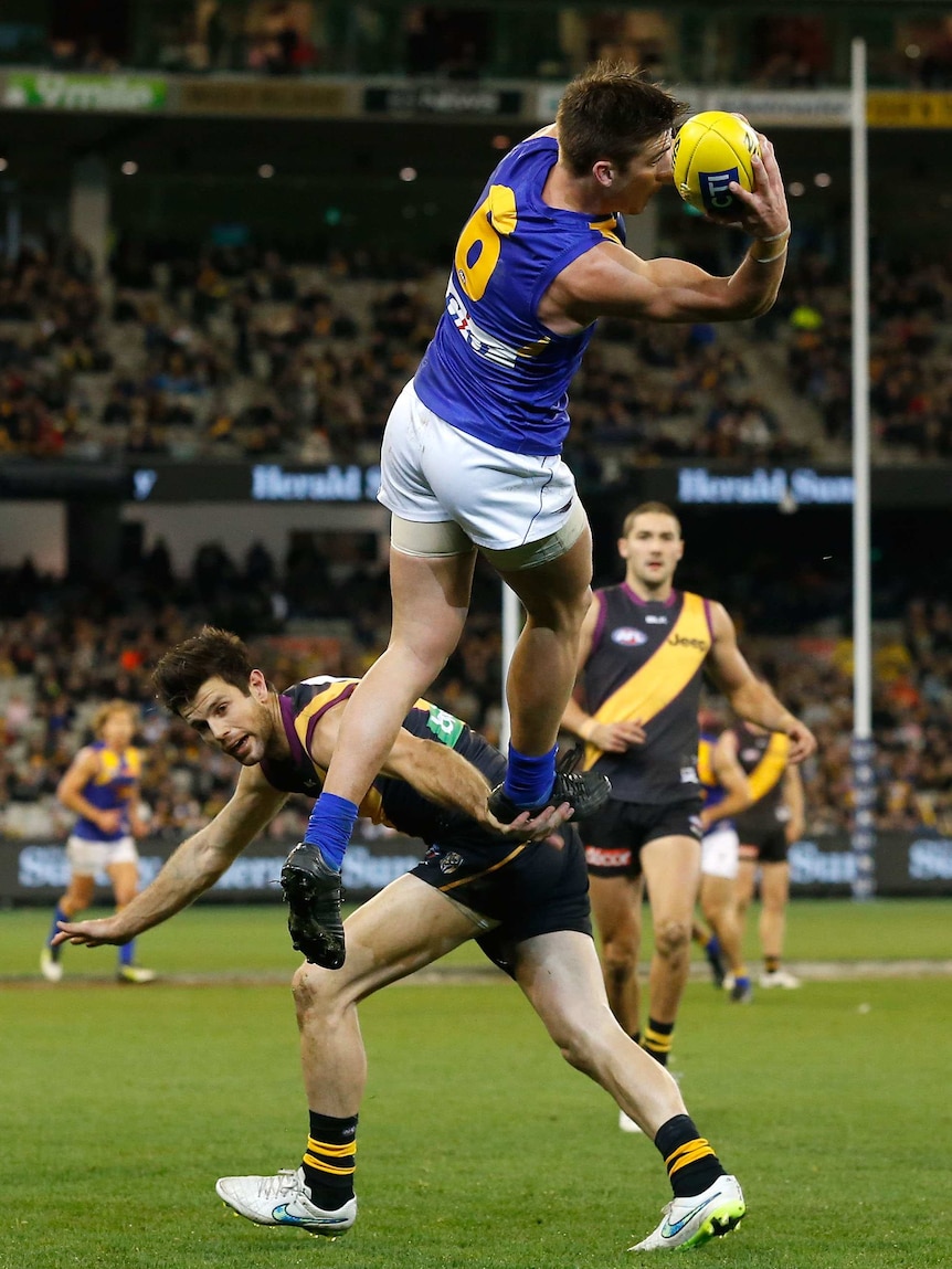 West Coast's Elliot Yeo takes a spectacular mark over Richmond's Trent Cotchin at the MCG.