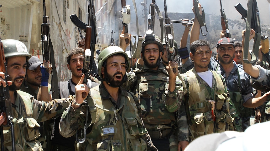 Violence continues ... Syrian soldiers celebrate after clearing the Damascus suburb of Midan.