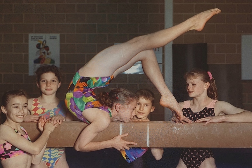 Gymnastics Odyssey JenSmith-on bar legs above head