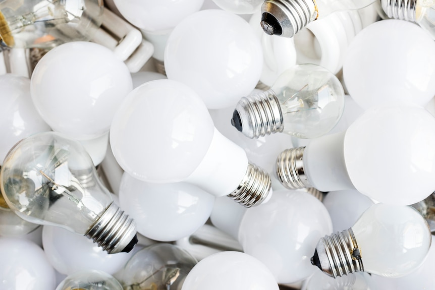 A pile of assorted lightbulbs including LEDs to depict how to reduce the cost of electricity bills over summer.
