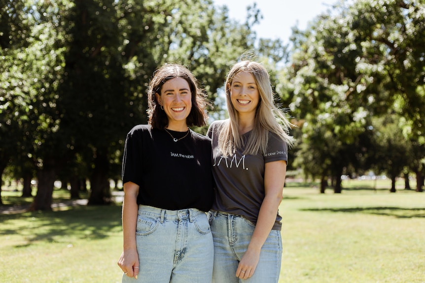Emma Clegg and Molly Rogers standing side-by-side in a park.