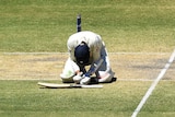 Craig Overton on his knees while batting during the Adelaide second Ashes Test.