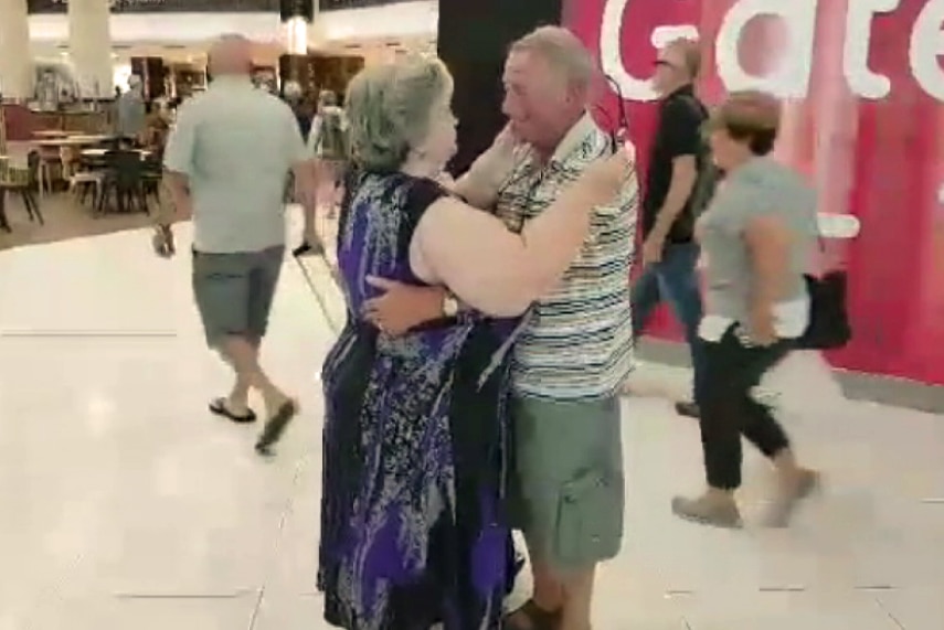 Brother and sister Bruce Stubblety and Barbara Crick embrace one another inside Perth Airport.