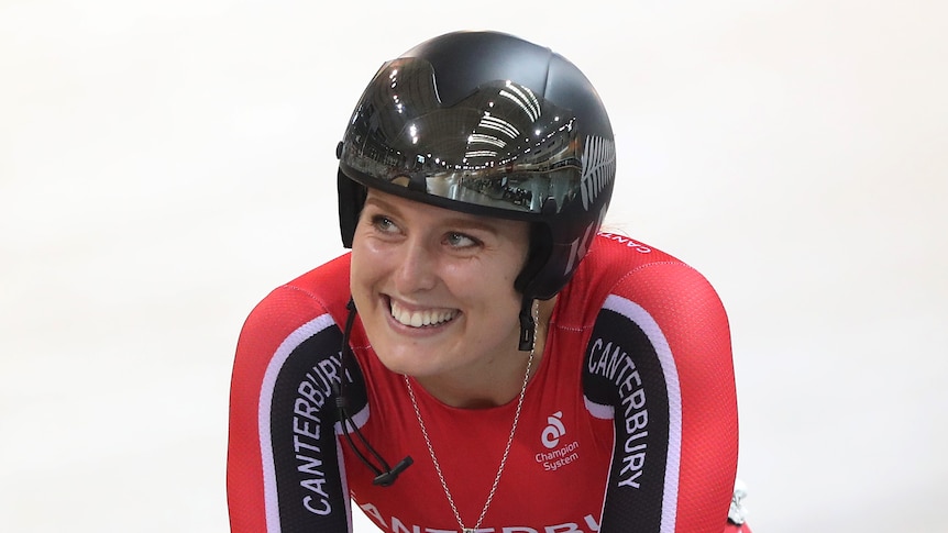 Olivia Podmore smiles while riding a bike