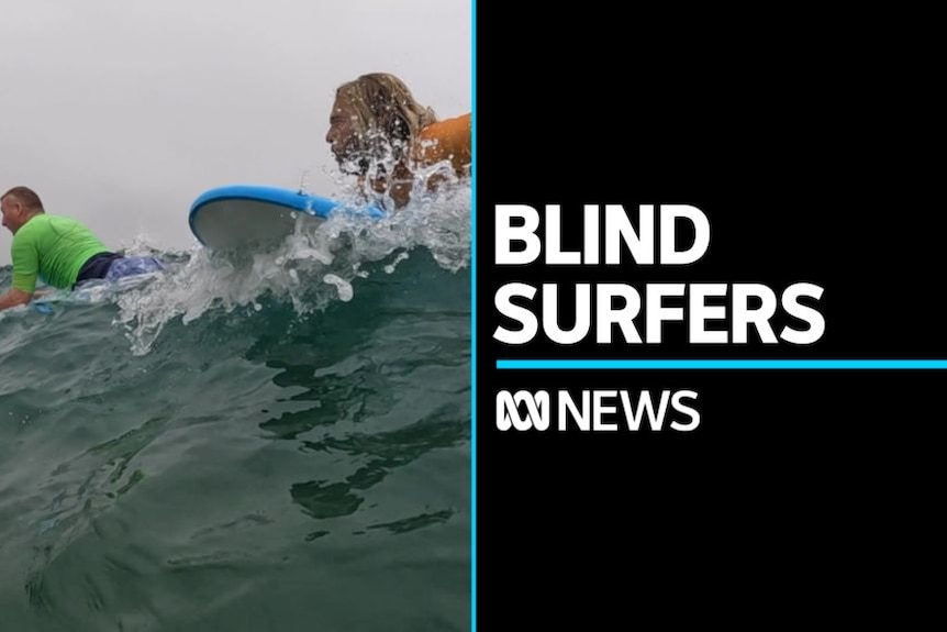 Blind Surfers: Two men on their bellies on surfboards in the sea