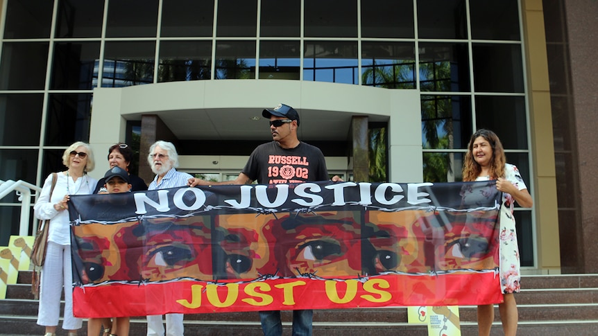 Marlon Dodson (left in cap) from Broome holds a protest sign with John Dodson and Theresa Rowe