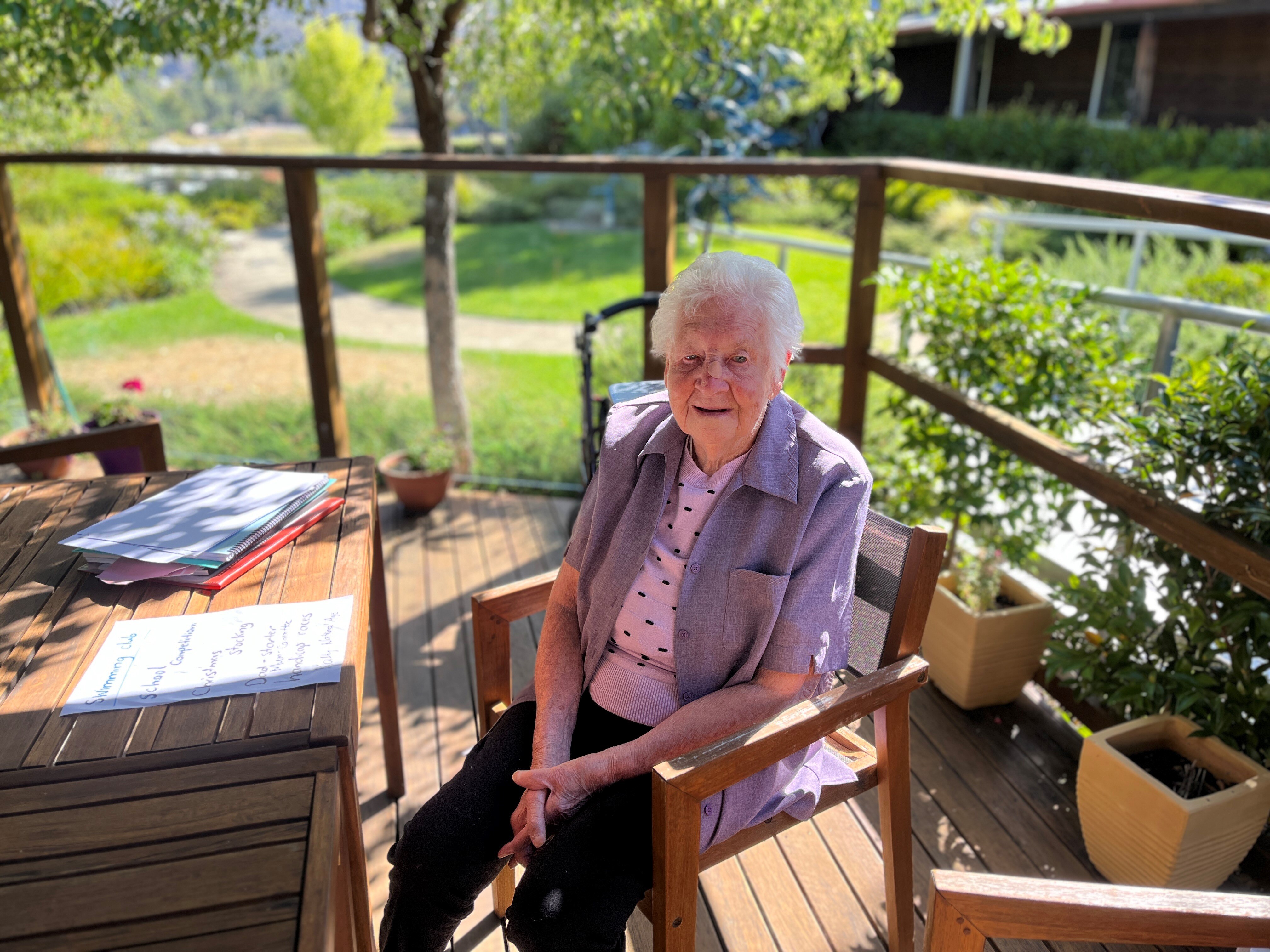 97 year old Nita Davey sits in a lovely garden in New Norfolk