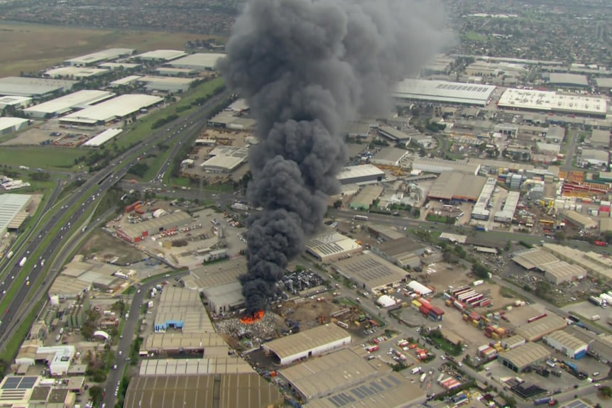 Smoke rising from a burning factory fire.