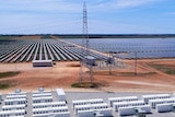 An aerial photo of batteries and solar panels in a dry landscape