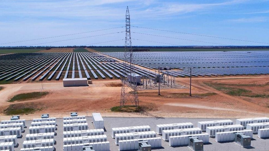 An aerial photo of batteries and solar panels in a dry landscape