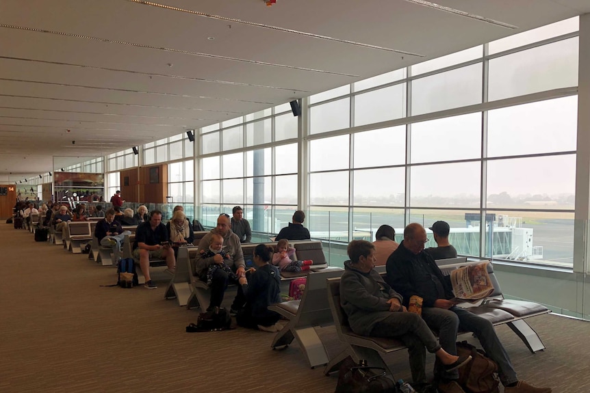 Passengers left stranded at Adelaide Airport due to heavy fog.