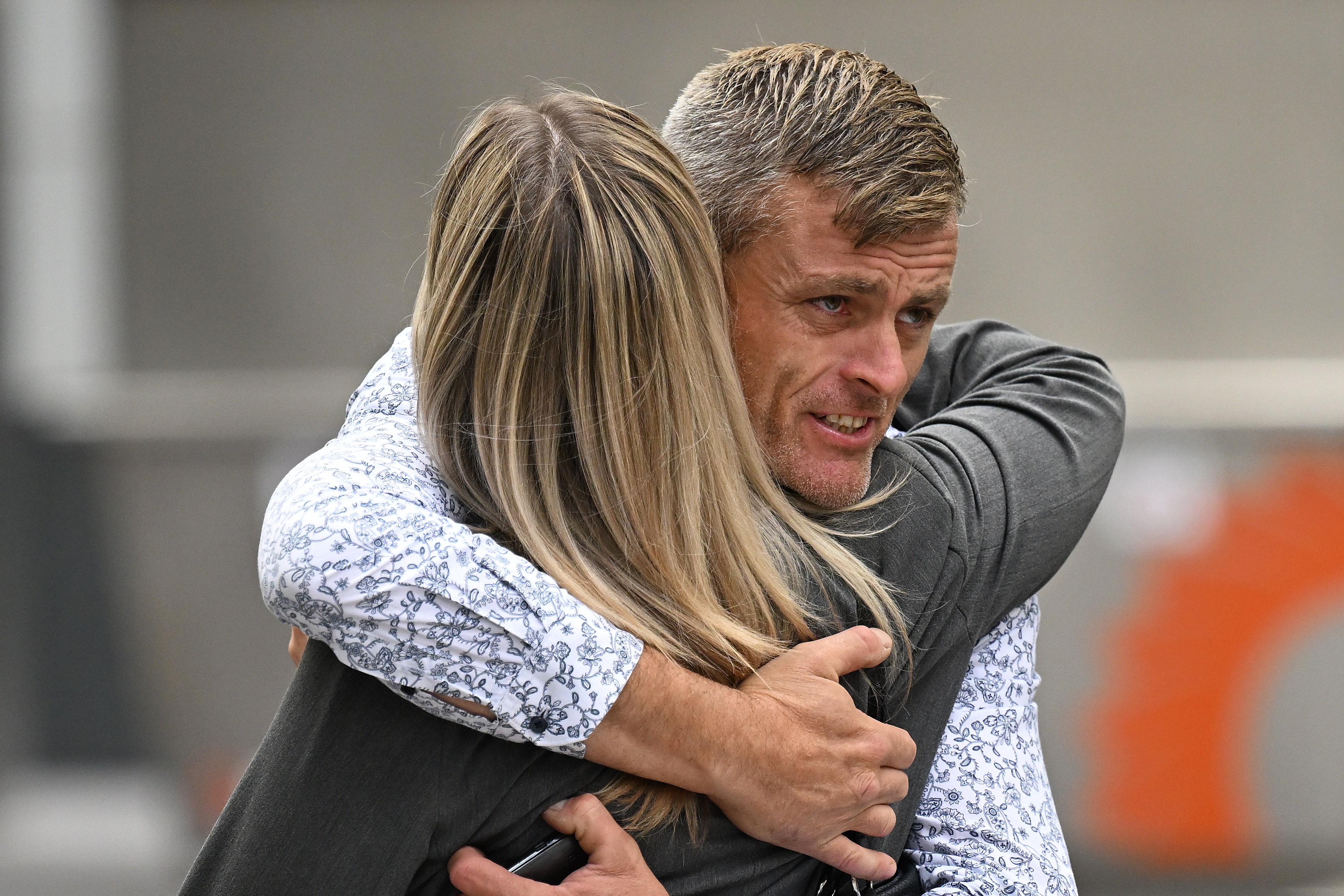 Bryan Beattie hugs a prosecutor outside court.