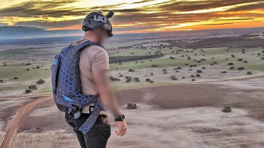 A photo of a man about to skydive.