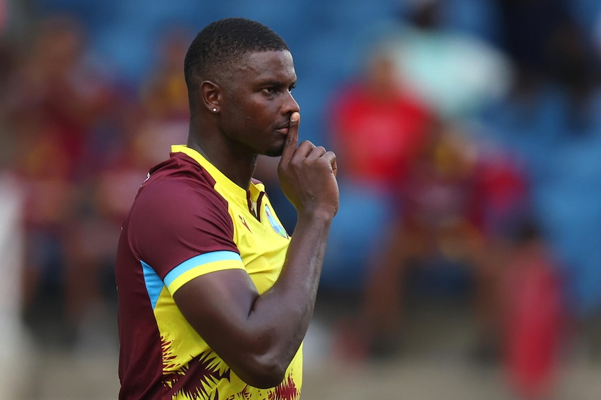 Jason Holder holds his fingers to his lips