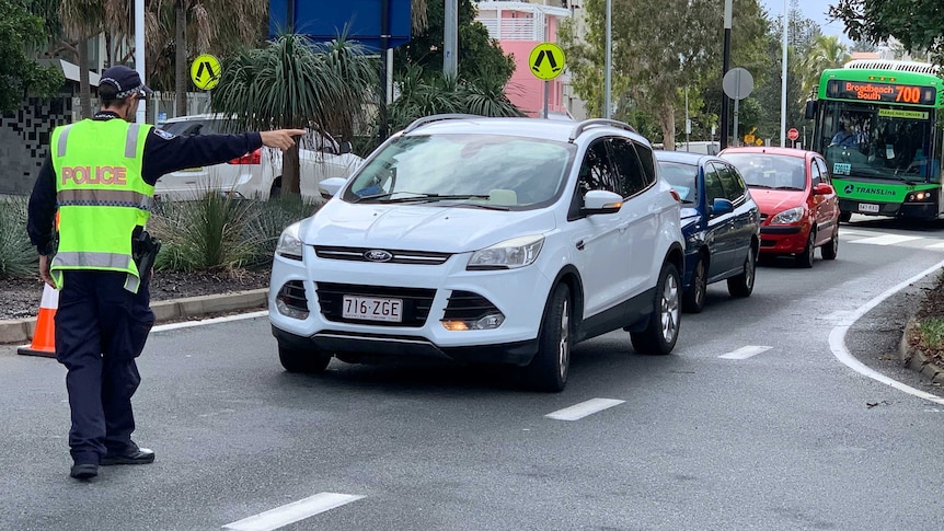 Police direct traffic at border check point in Coolangatta