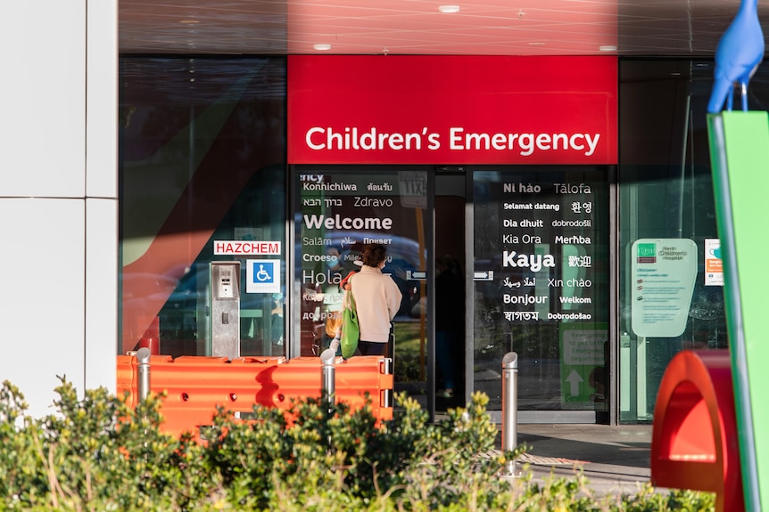 A red sign with the words "Children's Emergency" above a door.
