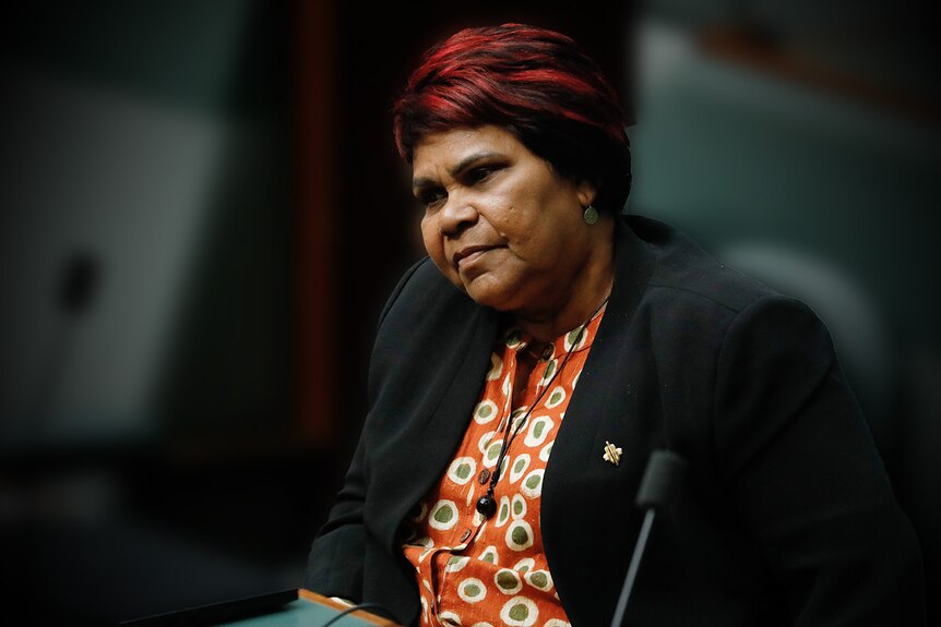 An Aboriginal woman sits in Parliament