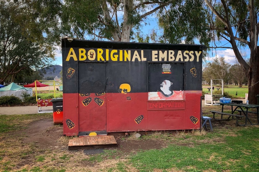 A permanent structure painted in the colours of the Aboriginal flag.